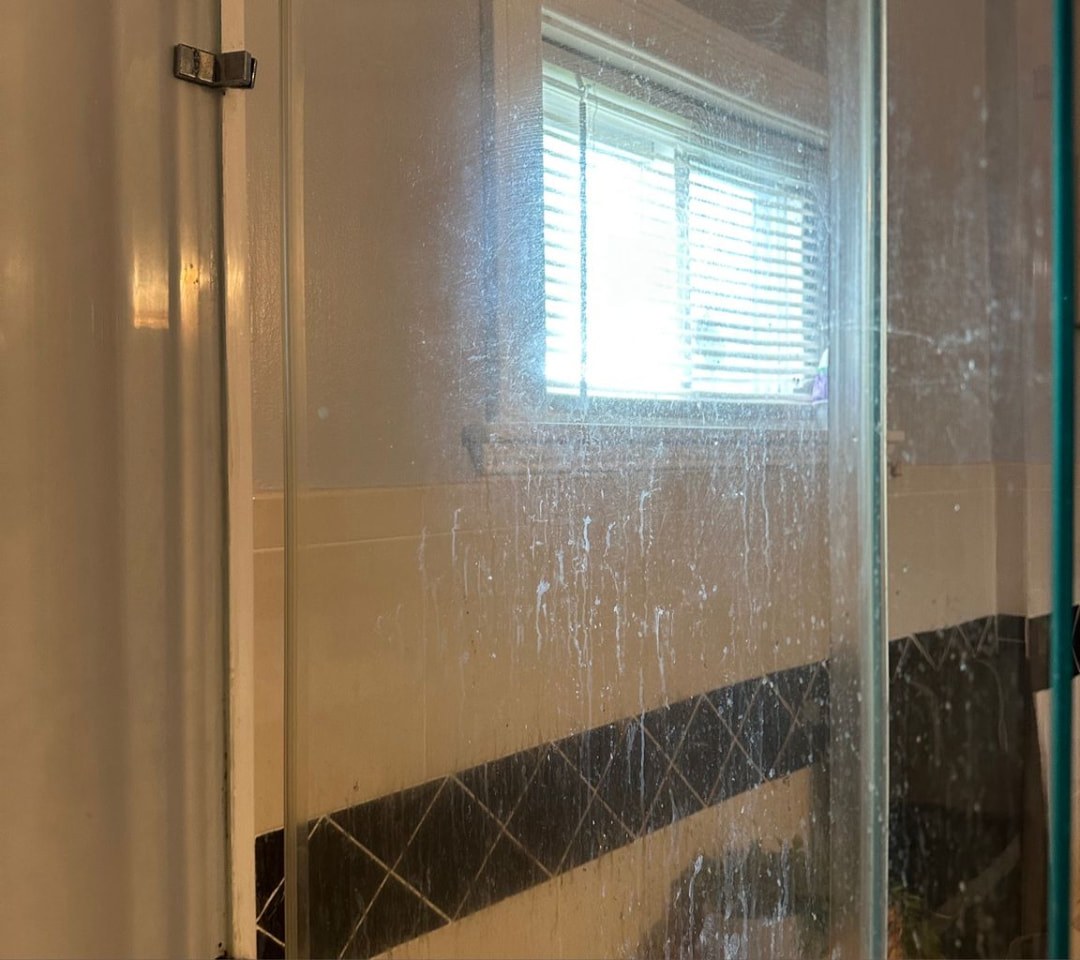 Shower glass restoration — before cleaning